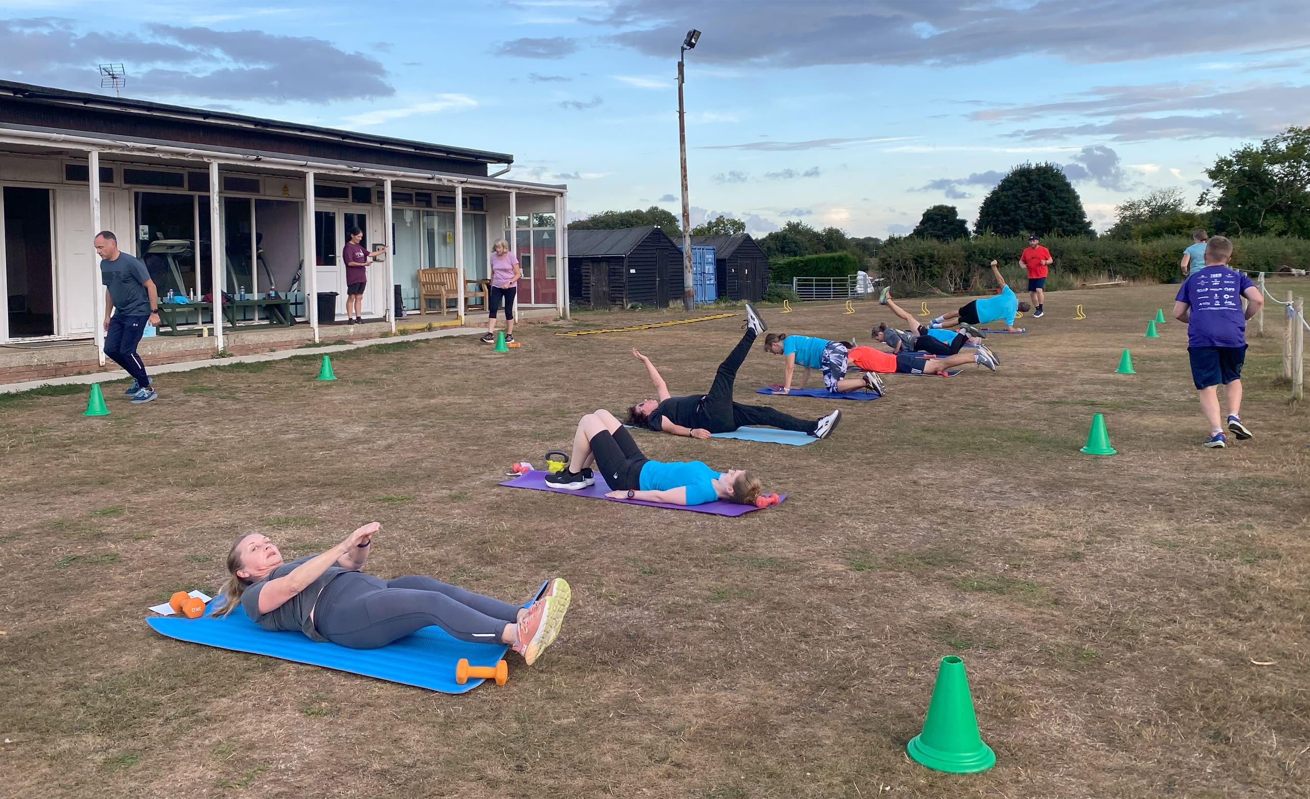 Line of people exercising on the grass
